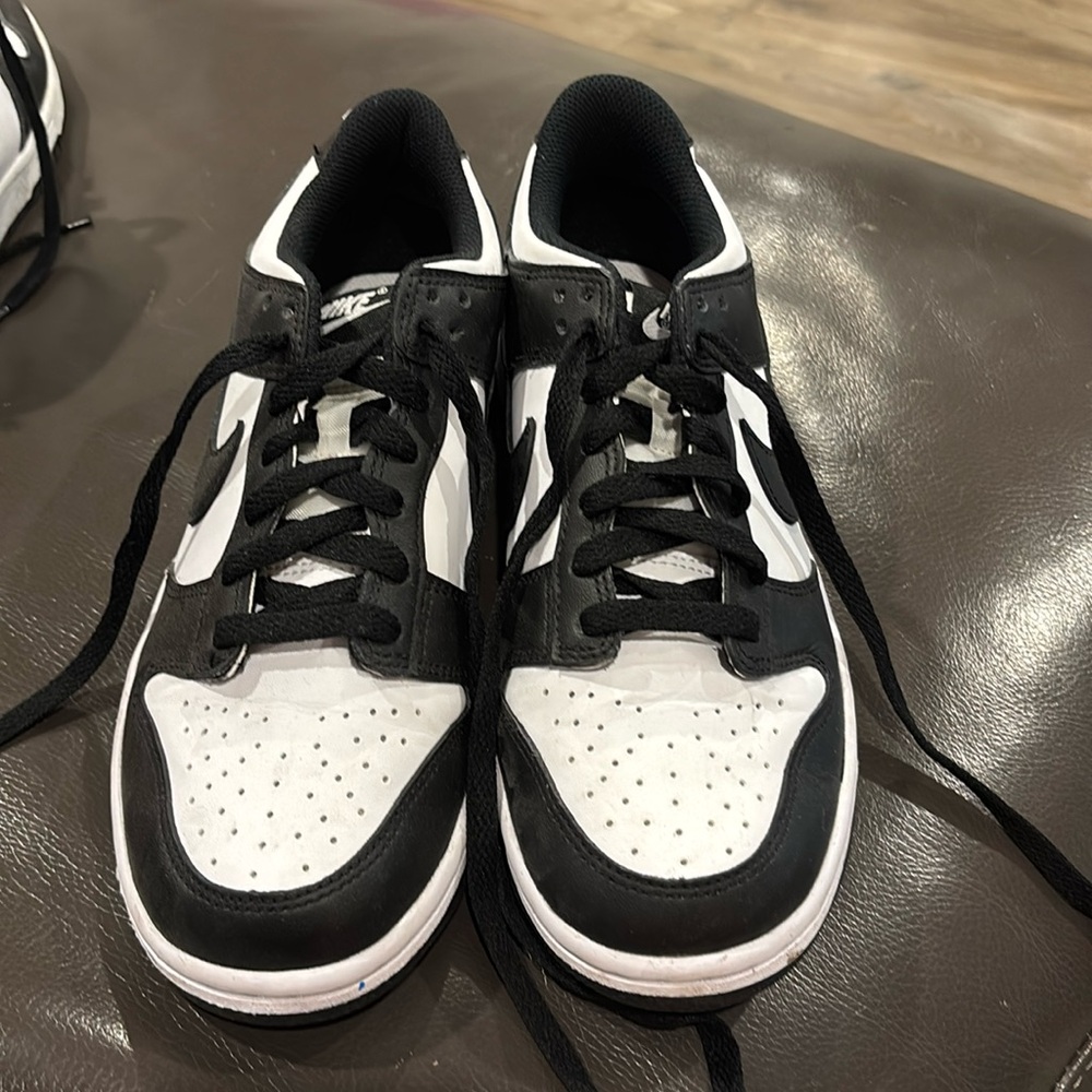 Kids pandas dunks been used gently use. Colors black and white.